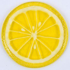 a lemon slice is cut in half on a white surface