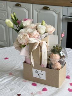 a box filled with flowers on top of a table