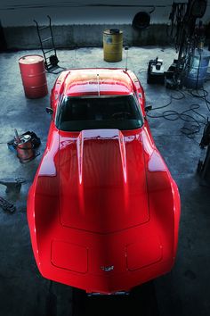 a red sports car parked in a garage