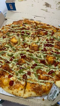 a large pizza sitting on top of a cardboard box