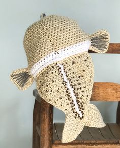 a crocheted fish sitting on top of a wooden chair