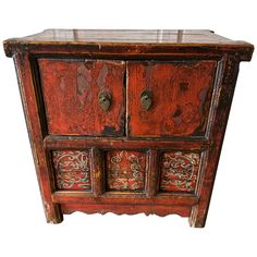 an old wooden cabinet with two doors and carvings on the front, sitting against a white background