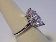 Natural Kunzite Solitaire Ring that weighs in at 5.84 carats. The Marquise cut gemstone is 18mm N/S, 8mm E/W, 1.77mm at shank and 8.5mm rise off of the finger. The ring is set in a heavy 14K white gold basket type mounting with gold tips to protect the stone. The mounting is substantial weighing 4.5 grams of solid 14K white gold. Currently a size 8, the ring can be sized up or down. Would make a fantastic engagement ring. The gemstone is a pinkish lavender which changes some in the light. This i Gold Basket, Gold Tips, Etsy Wedding Rings, Solitaire Ring, Cufflinks, Wedding Rings, White Gold, Engagement Rings, Stone