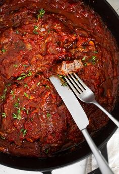 a skillet filled with meat and tomato sauce