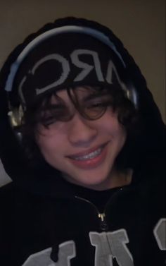 a young man wearing headphones and a hoodie with the word mrq on it