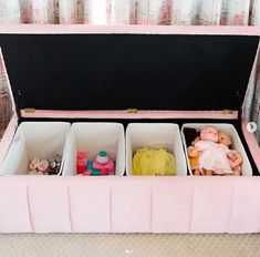 an open pink suitcase filled with dolls and toys