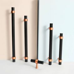 three black and gold poles standing next to each other