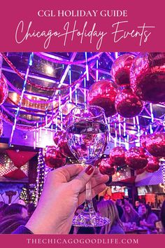 a person holding up a wine glass with the words chicago holiday guide on it in front of