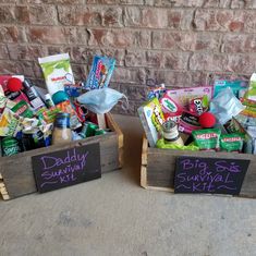 two wooden boxes filled with different types of snacks and condiments on the ground