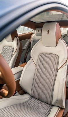 the interior of a car with beige and white leather