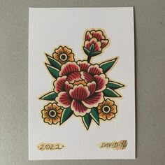 the back side of a card with flowers on it