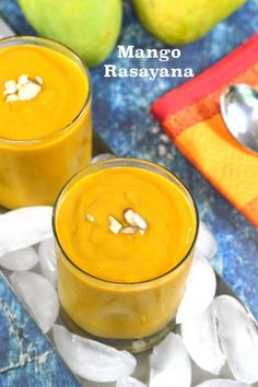 two glasses filled with mango rasaya on top of ice