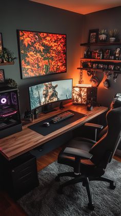 a computer desk with two monitors and a keyboard on it in front of some pictures