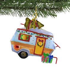 an ornament shaped like a camper with presents hanging from it's roof