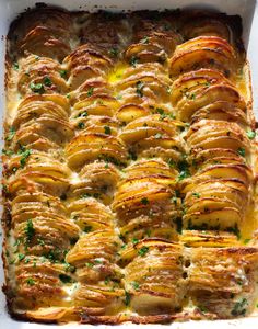 a casserole dish with potatoes and parsley