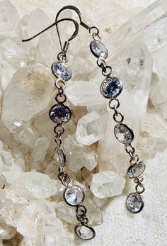 Featured is a lovely pair of sterling silver & crystal dangle earrings. Long clear cubic zirconia crystal dangle earrings. Silver is marked 925. Stones are a round brilliant cut, flat cut surface on one side, with the other side coming to a point. I have tried to show this in pictures. All clear stones are clear and sparkly. These earrings look gorgeous when worn. Definitely an eye catcher. Cz stones measure 5.5mm round. Earring measure 3 1/8 inches long with ear wires. Dangle earrings are i Dazzling Clear Cubic Zirconia Jewelry, Silver Sparkling Crystal Earrings With Cubic Zirconia, Silver Sparkling Cubic Zirconia Crystal Earrings, Dazzling Diamond White Dangle Crystal Earrings, Clear Cubic Zirconia Jewelry With Diamond Accents, Clear Cubic Zirconia Jewelry With Sparkling Stones, Dazzling Dangle Crystal Earrings, Clear Cubic Zirconia Jewelry With Prong Setting, Sterling Silver Dangle Diamond Earrings With Sparkling Stones