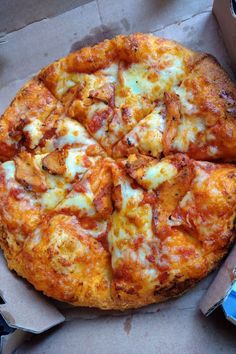 a pizza sitting on top of a cardboard box