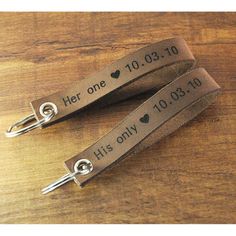 two personalized leather keychains with hearts on them, one for her and the other for him