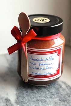 a jar with a spoon in it sitting on a counter