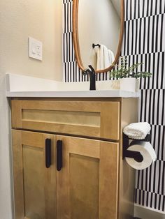 a bathroom with a sink, mirror and towel rack