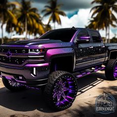 a purple and black truck is parked on the street with palm trees in the background