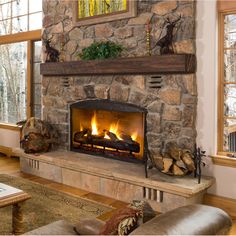 a stone fireplace in a living room with wood burning