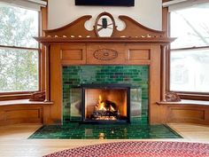 a living room with a fire place in the center and two windows on both sides