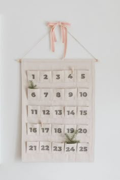 a white wall hanging with a calendar on it