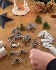 someone is making christmas decorations out of toilet paper rolls and other items on the table