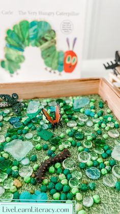 the very hungry caterpillars are on the green rocks in the tray with water