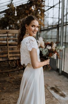 a woman in a white dress holding flowers