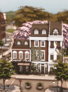 a model of a town with lots of trees and flowers on the side of it