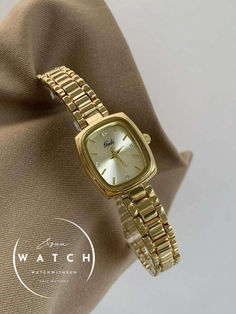 This stylish watch features a small rectangular dial made of mother-of-pearl, available in gold, white, blue, and brown colors. Paired with a sleek gold stainless steel strap, it offers both comfort and versatility, making it perfect for any occasion. Its minimalist and modern design complements various styles, making it a favorite among women. Rectangle Face, Mother Of Pearl Bracelet, S Bracelet, Bracelet Watches Women, Stylish Watches, Watches For Women, Classic Gold, Square Watch, Women's Watch