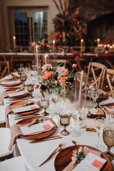 a table set with place settings and candles