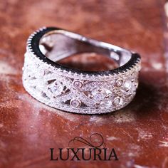 a diamond ring sitting on top of a wooden table