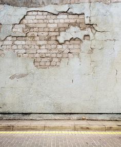 an old brick wall that has been torn down and is being used as a background