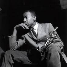 a black and white photo of a man with a saxophone