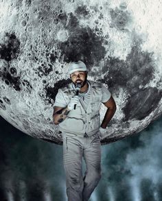 a man is standing in front of the moon