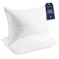 two pillows with white stripes on them and a tag hanging from the pillow case that says, don't wake when you sleep