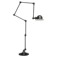 a black lamp on a white background with one light turned on and the other turned off