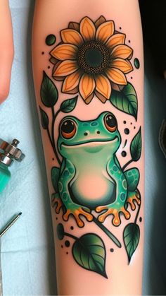 a frog with a sunflower tattoo on its leg