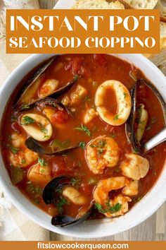 a bowl of seafood soup with bread on the side