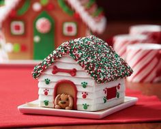 a gingerbread house decorated with icing and sprinkles on a table