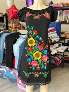 100% Authentic Mexican Dress  This Dress is gorgeous. Once size fit up to XL Color: Black  Size: XL It has elastic an the back of the dress  the floral wall remain the same but the embroidery colors vary on each dress Ebroidery Mexican Dress.Boho Chic Dress Folk Fabric Flowers Mexican Tunic Traditional Embroidery This Dress is perfect for those beach day or any occasion This Dress is meant to provide extreme comfort throughout the day The perfect gift for her Black Embroidered Knee-length Summer Dress, Black Knee-length Embroidered Summer Dress, Fitted Black Cotton Embroidered Dress, Black Fitted Cotton Embroidered Dress, Fitted Casual Black Embroidered Dress, Fitted Cotton Embroidered Black Dress, Black Cotton Embroidered Short Sleeve Dress, Black Cotton Embroidered Dress With Short Sleeves, Black Mexican Dress