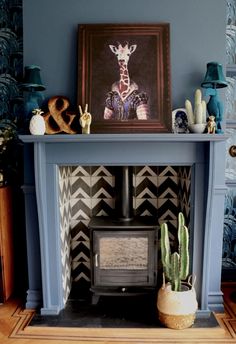 a living room with a blue fireplace and pictures on the mantels above it