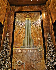 the empire state building in new york city is decorated with christmas lights and garlands