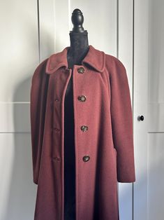 Vintage 80s wool coat Beautiful wool coat from 80s era. The coat has four big luxurious buttons and two pockets on the front side. It also has raglan sleeves. There are no tags, but material feels like wool blend. You can see a vibrant pattern on the inside, material is probably viscose. Lining is fully lined. Fits best women's size L or XL, but to be sure, check the exact measurements: Shoulders: 56 cm / 22 in Sleeves (from armpit):  36 cm / 14 in Lenght: 122 cm / 48 in Coat is in great vintage condition. All items are measured flat. Colors of the actual items can vary slightly from the colors on the images. *Comes without necklace.* **Vintage items may have minor flaws due to pre-loved wear and or age. If it is so, we always describe it in a listing.** Classic Burgundy Outerwear With Buttons, Vintage Long Wool Coat With Pockets, Vintage Single-breasted Long Pea Coat, Vintage Solid Color Single Breasted Outerwear, Vintage Solid Single Breasted Outerwear, Vintage Single-breasted Solid Outerwear, Vintage Solid Color Single-breasted Outerwear, Long Sleeve Outerwear With Button Closure In Vintage Style, Vintage Pea Coat With Button Closure