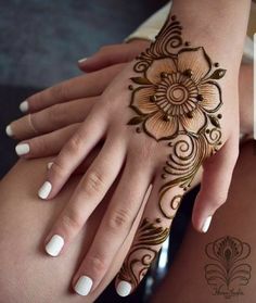 two hands with henna tattoos on them