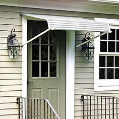 the front door of a house with an awning over it