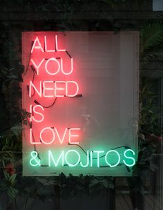 a neon sign that says all you need is love and mojitos